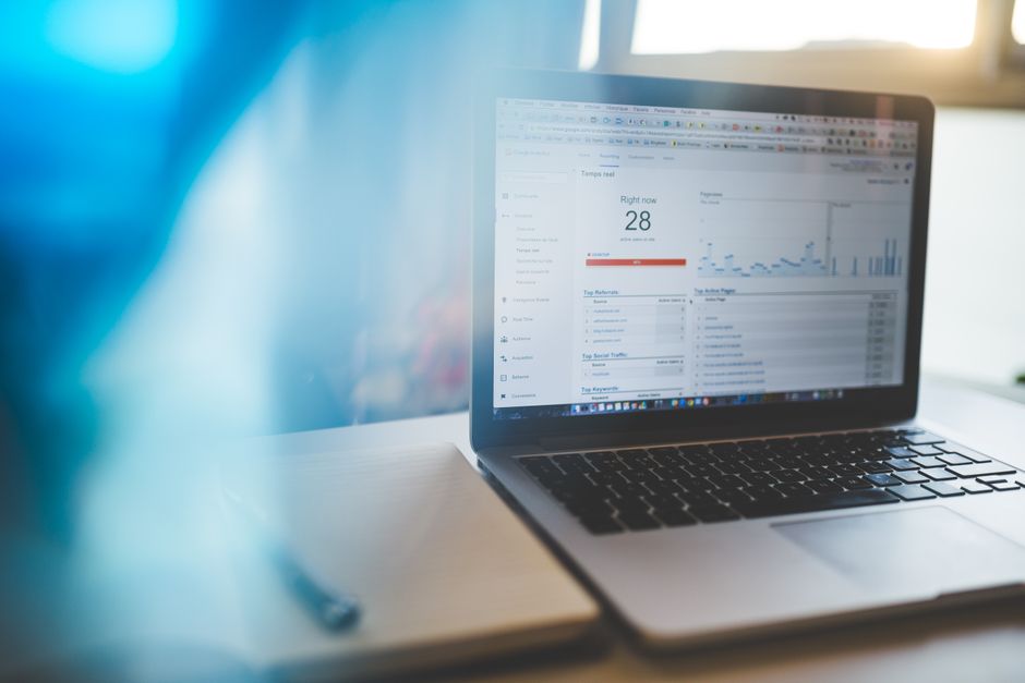 A marketer reviewing a Google Ads performance dashboard on a laptop