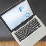 Marketer comparing Meta Ads and Google Ads performance on a laptop dashboard